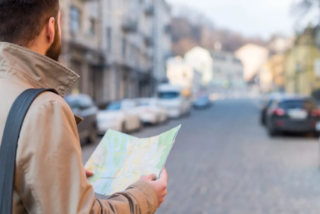 A person along a road with a map in his hands