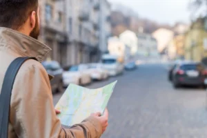 A person along a road with a map in his hands